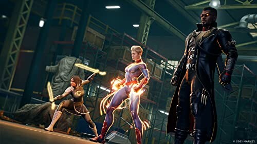 Three superheroes in action pose in a warehouse.